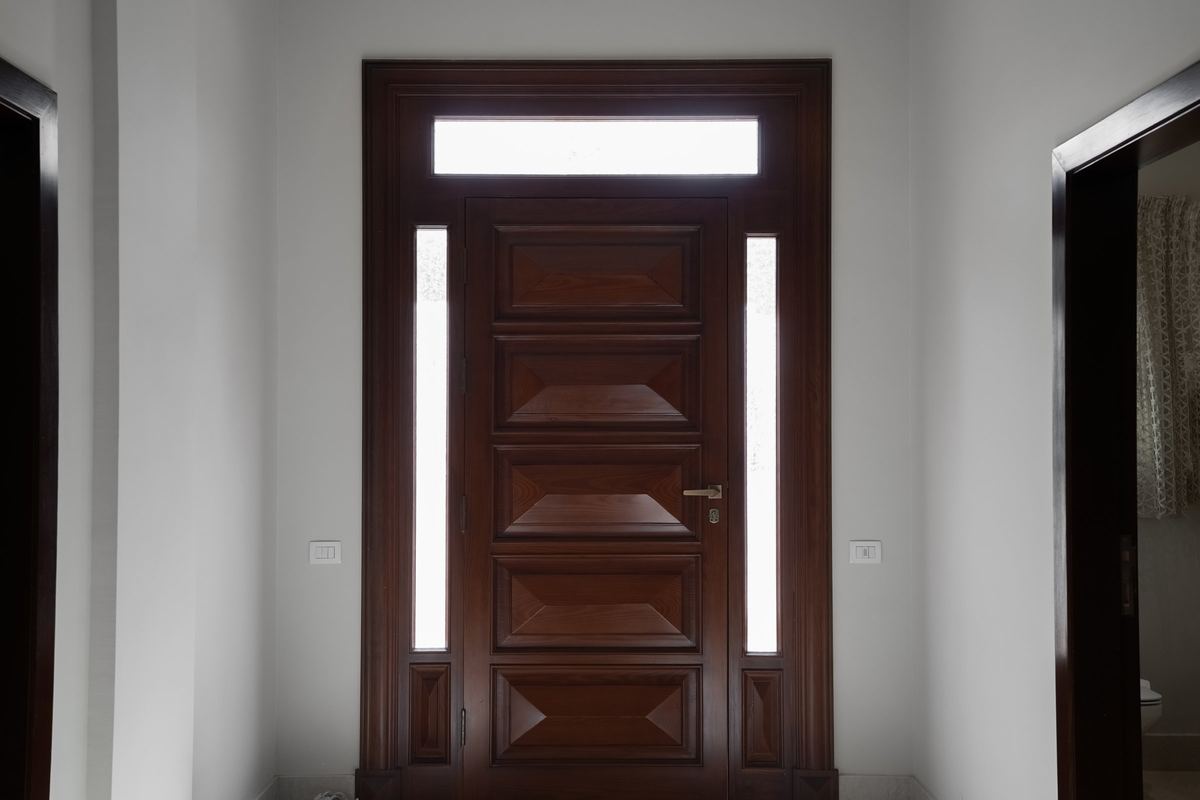 L-Villa II front door: solid timber door with glass side panels