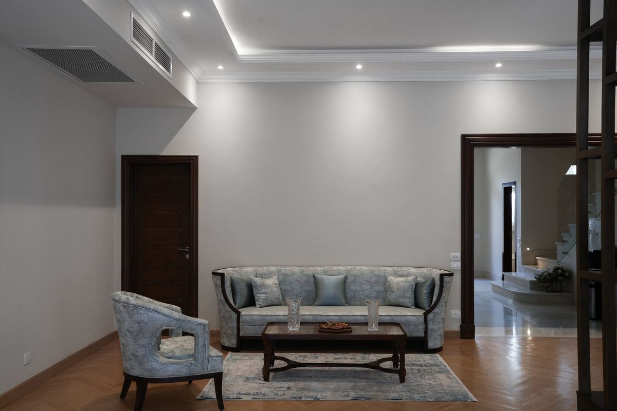 The sitting room as delivered: sofa and armchair, the door on the left and the opening to the stairs