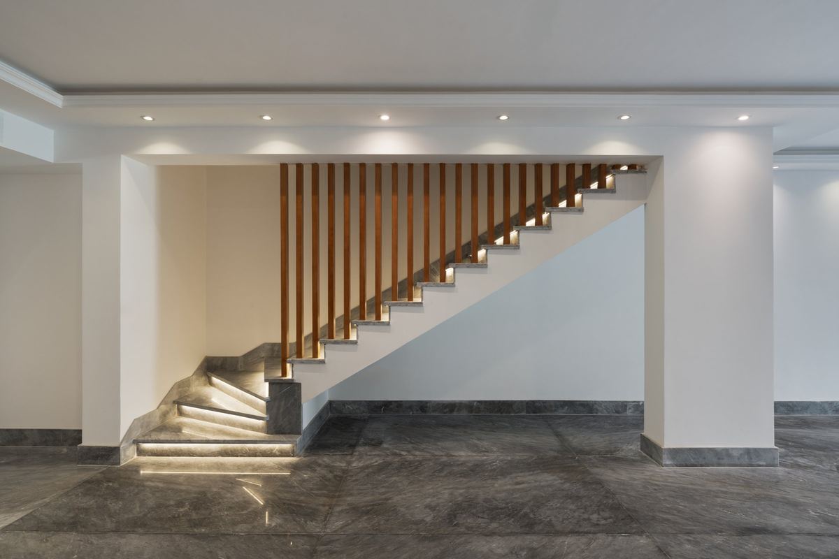 M-Villa finished staircase: marble treads, timber slat screen and hidden step lighting