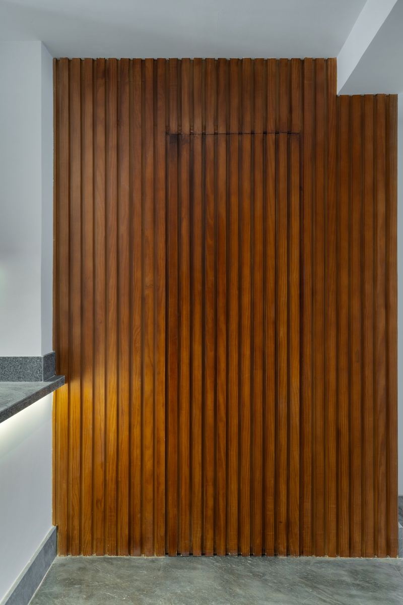 M-Villa hidden door open in the timber slat wall