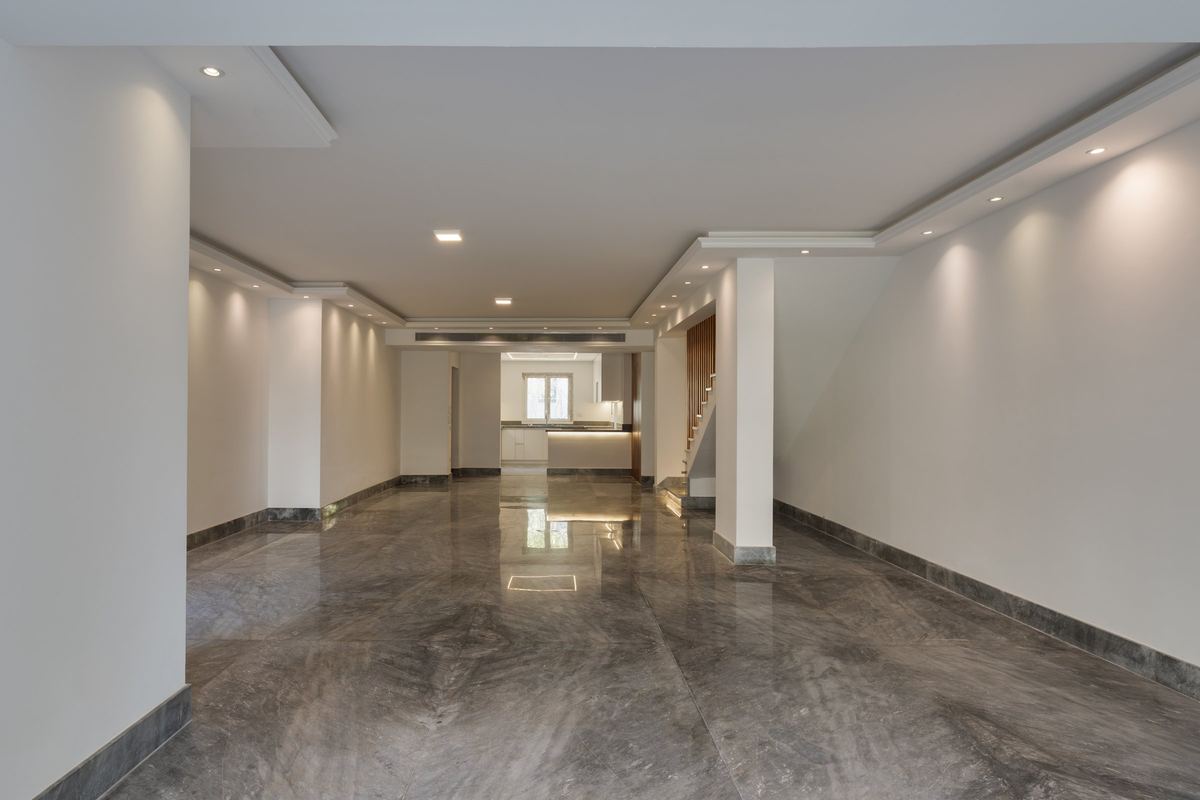 After: M-Villa reception: polished marble floor and recessed ceiling lighting
