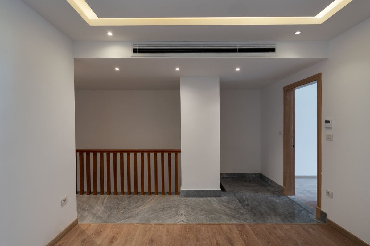 M-Villa upper landing: timber balustrade and wood floor