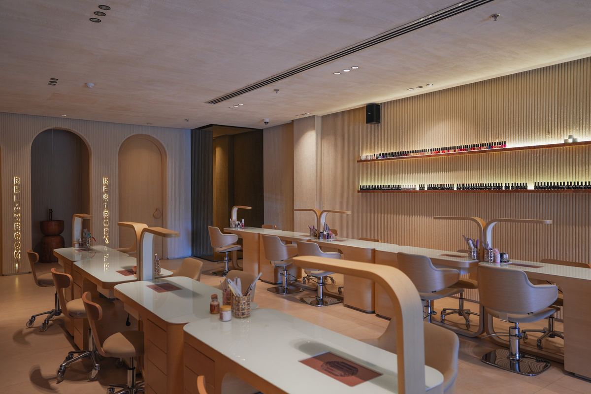 The nail bar as delivered: manicure tables, arched niches and lit shelves