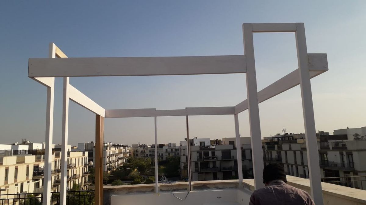 Before: Sodic rooftop during works: bare steel pergola frame