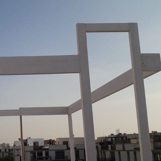 S-Roof during works: the white pergola frame going up against the sky
