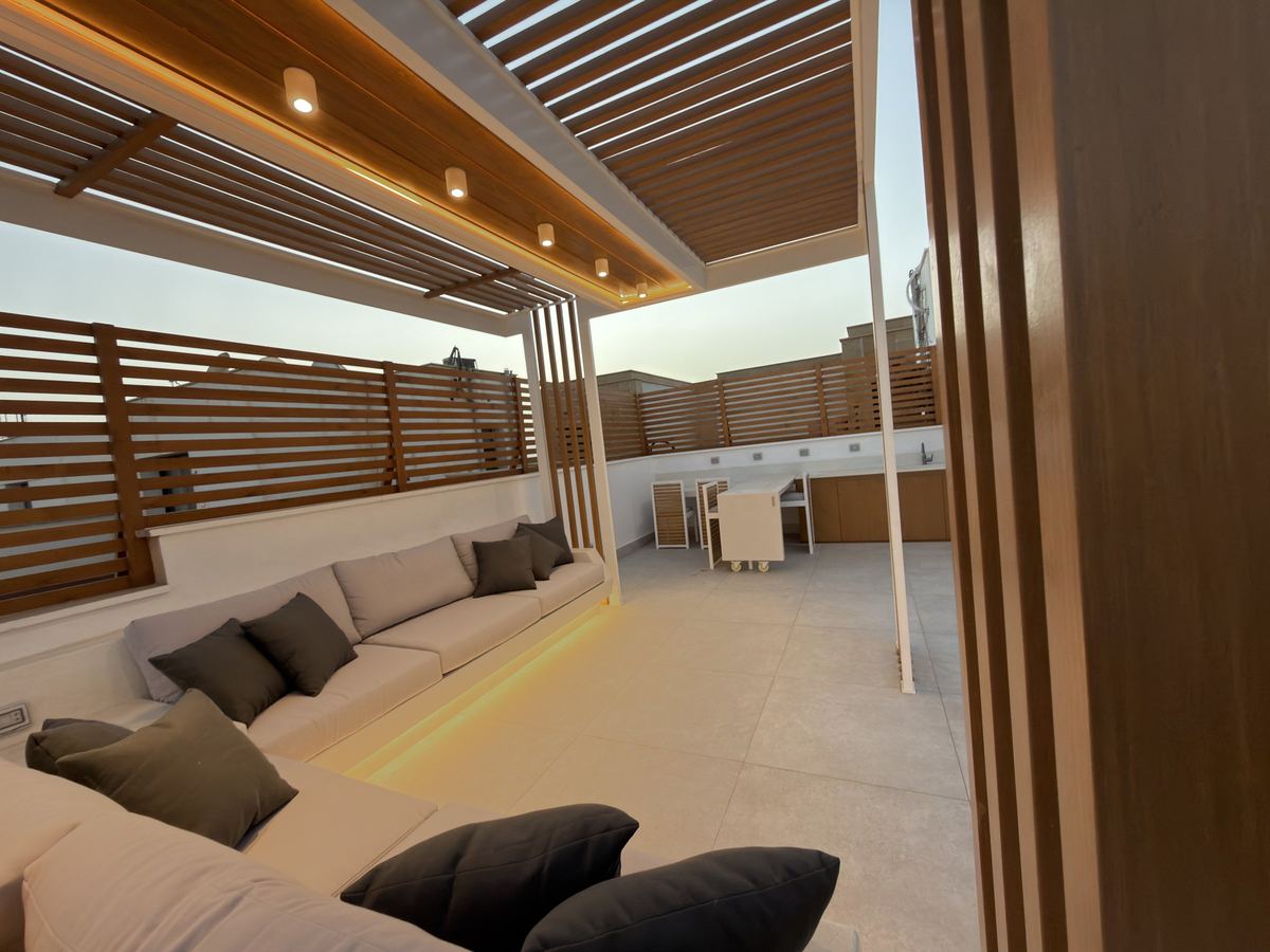 Inside the pergola as delivered: terrazzo couch with hidden LED and ceiling lights